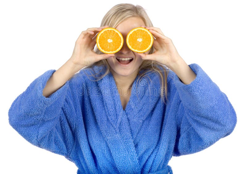 Young blonde woman with halfs of orange