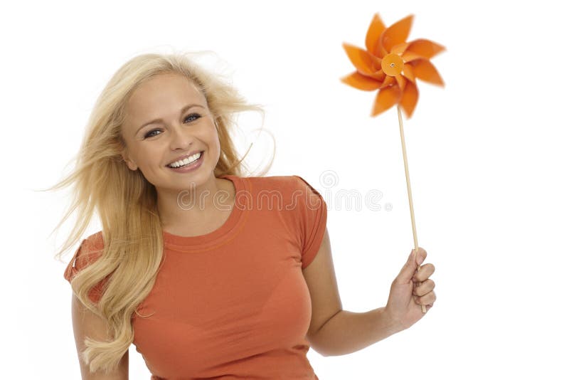 Young blonde woman with pinwheel smiling