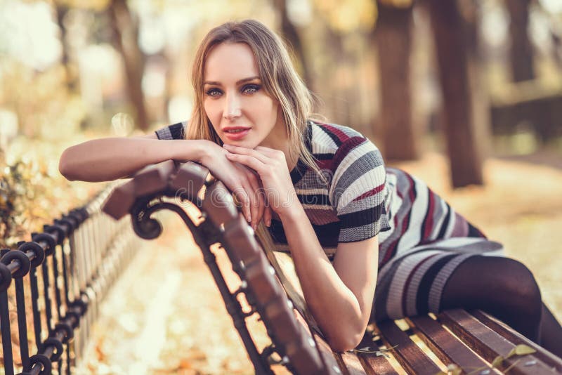 Young Blonde Woman Sitting on a Bench of a Park Stock Photo - Image of ...