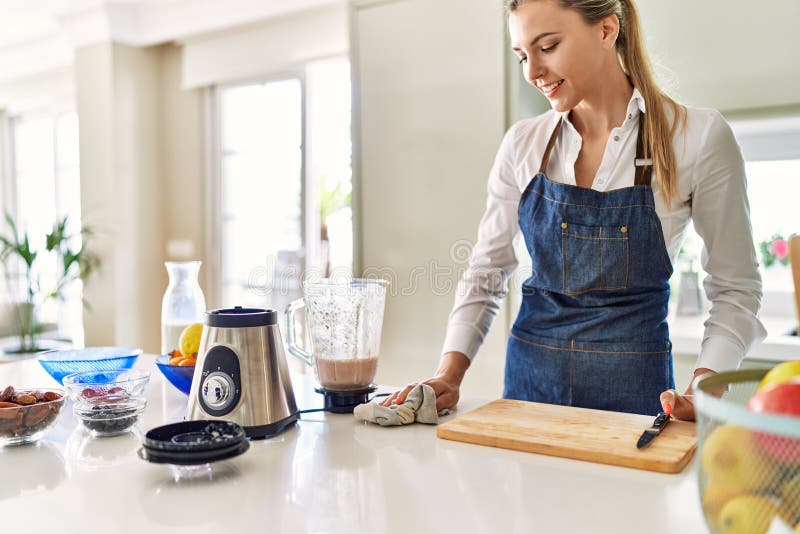 Young Blonde Woman Smiling Confident Cleaning Table at Kitchen Stock ...