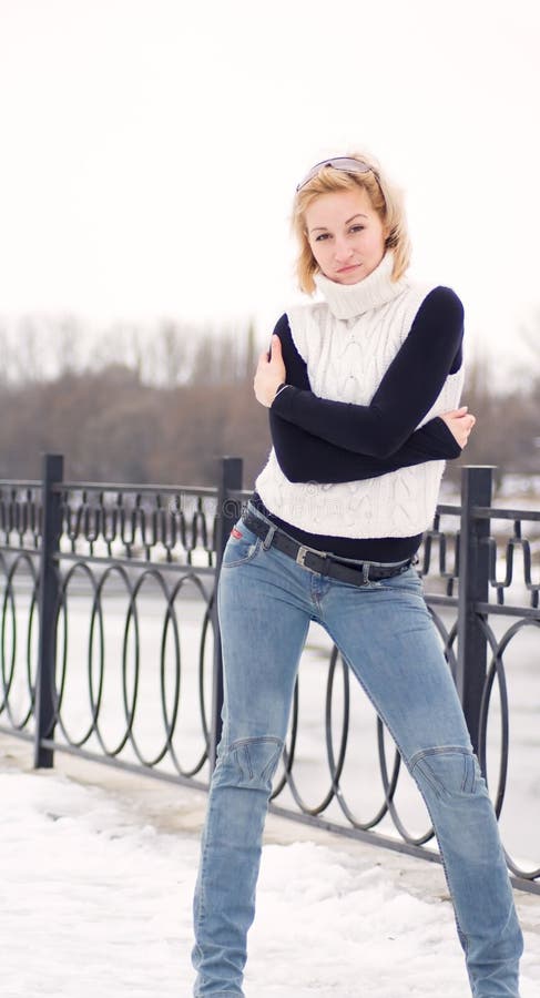 Young blonde women against a background of snow