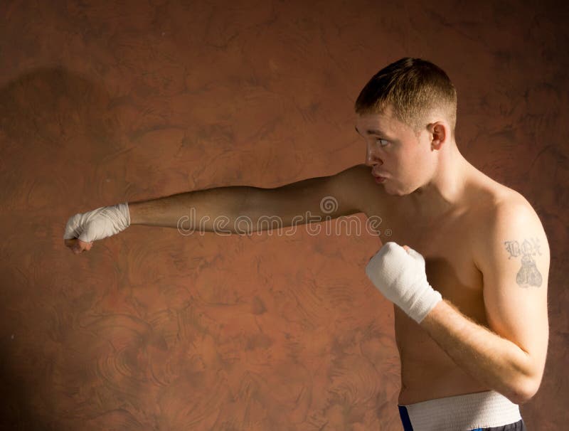 Young boxer in training throwing a punch