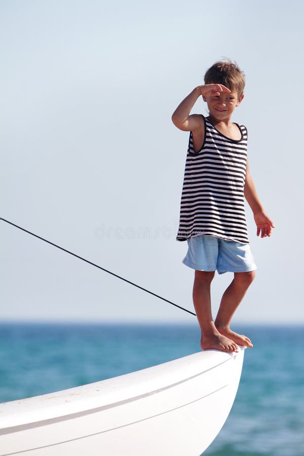 Young boy on board of sea yacht