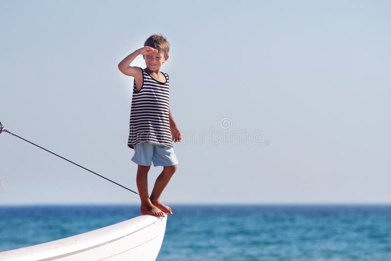 Young boy on board of sea yacht