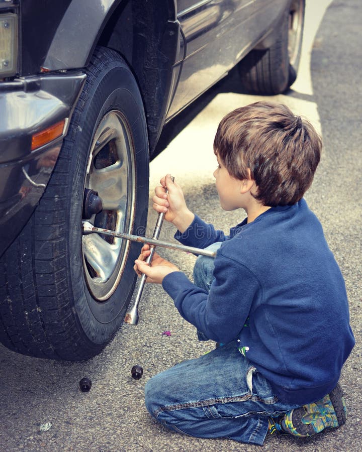 Young Boy Changing Tire