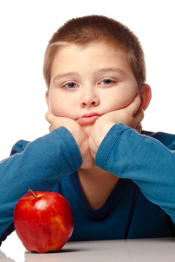 Young Boy deciding to eat an apple