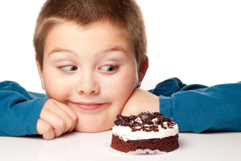 Young boy deciding to eat a dessert