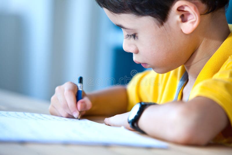 Young boy doing his homework royalty free stock photography