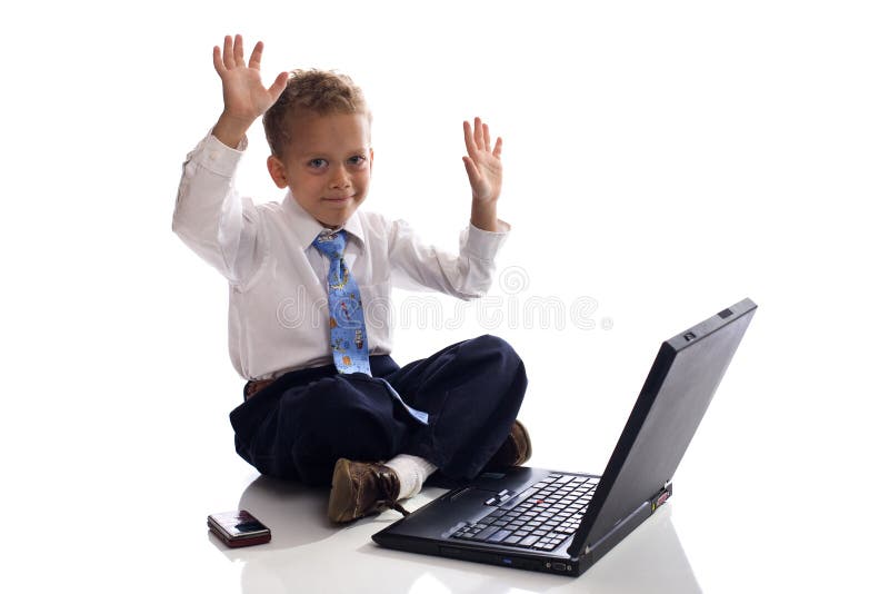 Young boy dressed as businessman with laptop