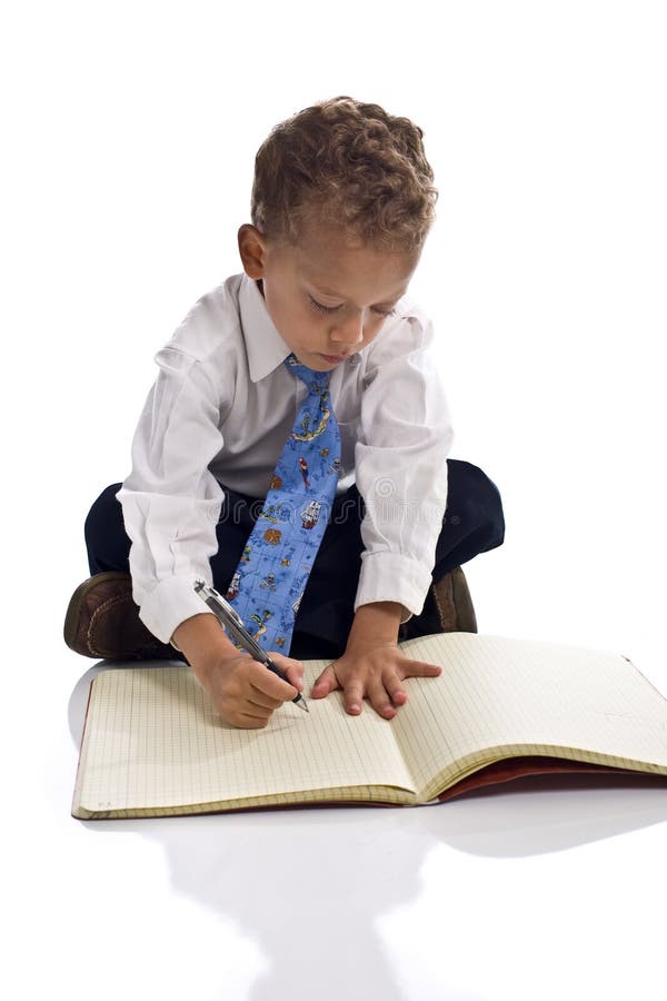 Young boy dressed as businessman with notepad