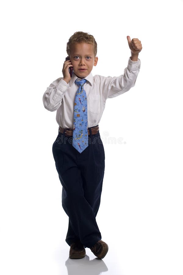Young boy dressed as businessman talks on celphone