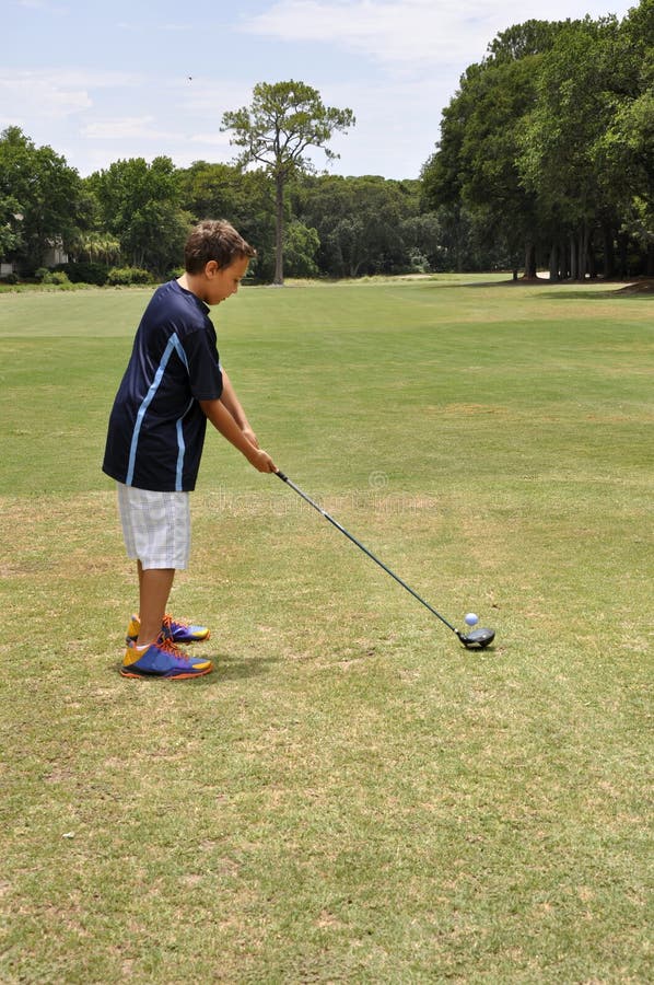 Young Boy Driving a Golf Ball Stock Image Image of adolescent
