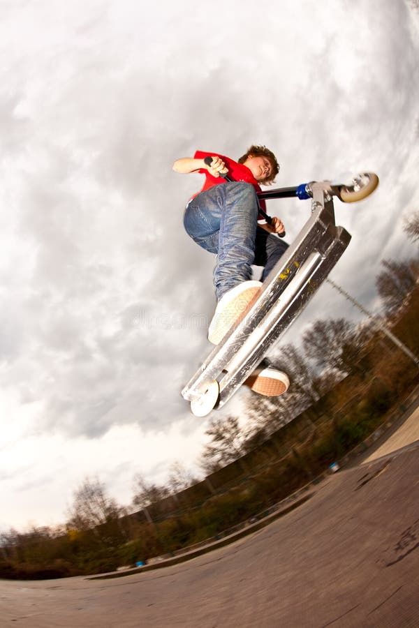 Young Boy Enjoys Riding a Scooter Stock Photo - Image of male ...