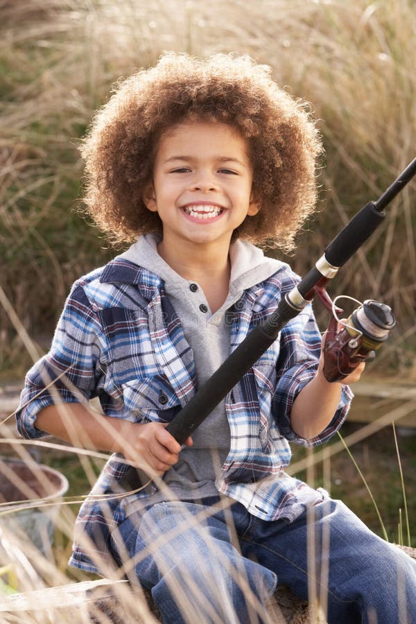 Young Boy Fishing At Seaside