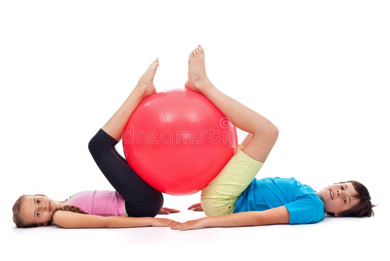 Young boy and girl exercising with a large gymnastic rubber ball