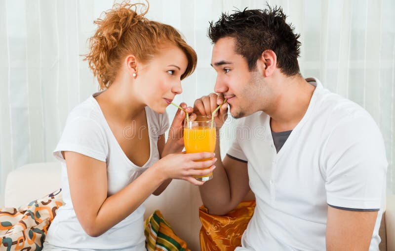 Young boy and girl with a glass of orange juice