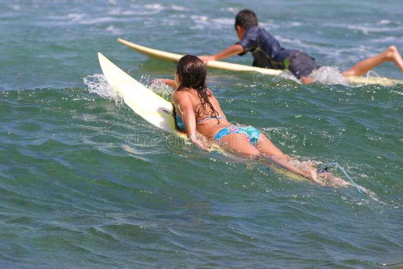 Young boy and girl go surfing in Hawaii