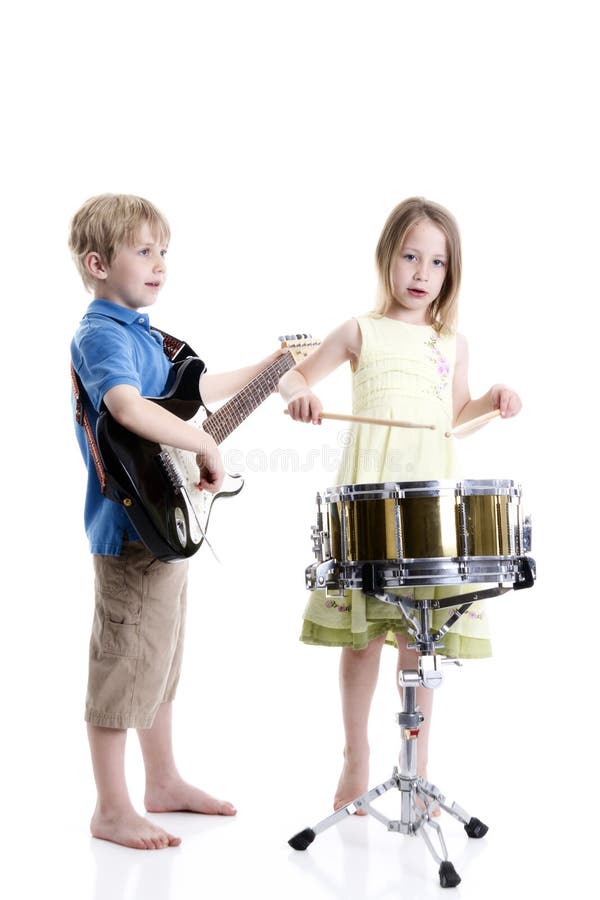 Young boy playing guitar and young girl playing drums. Young boy playing guitar and young girl playing drums