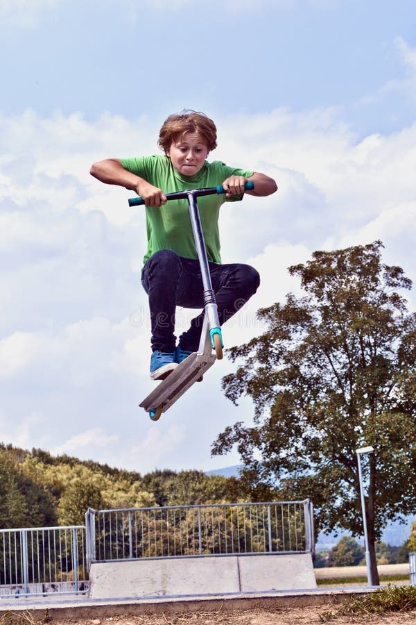 Young boy going airborne with his scooter