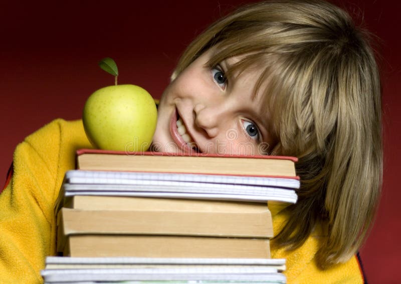 Young boy holding books