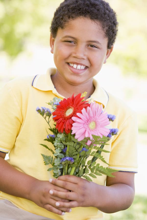 18+ Smiling young boy holding flowers Free Stock Photos StockFreeImages