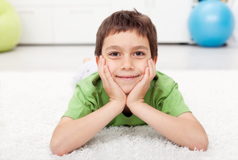 Young Boy Laying on the Floor Stock Photo - Image of happiness, little