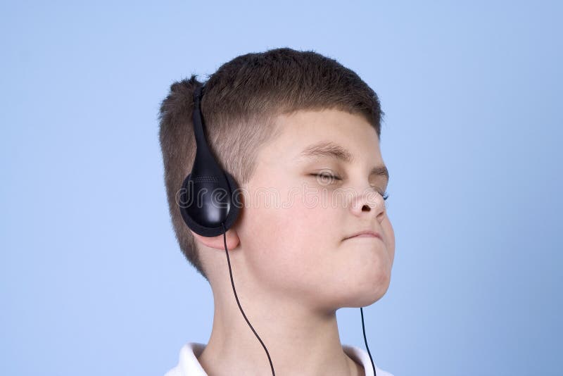 Young boy listening to music on headphones