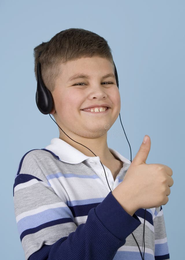 Young boy listening to music on headphones