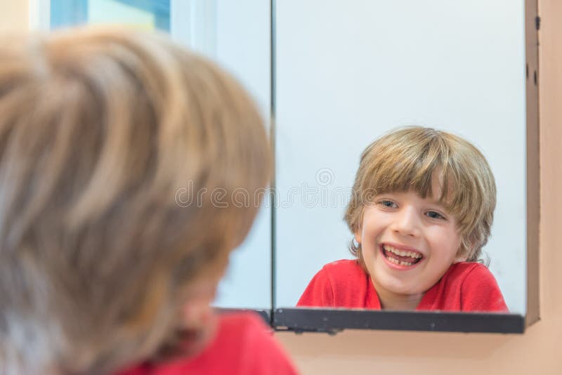 Young Boy Looking at Himself in Mirror Stock Image Image of