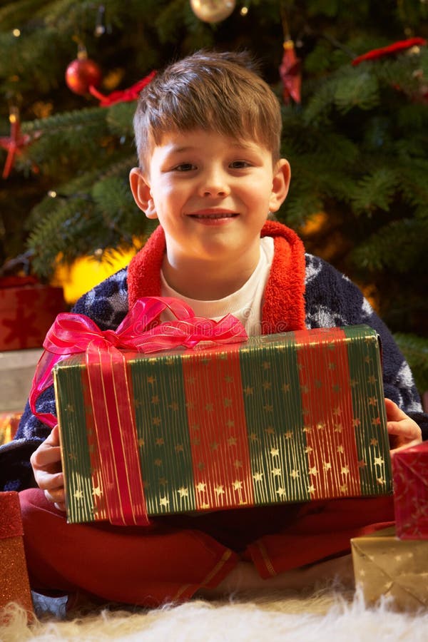 Young Boy Opening Christmas Present stock photo Young Boy Opening Christmas Present stock photo