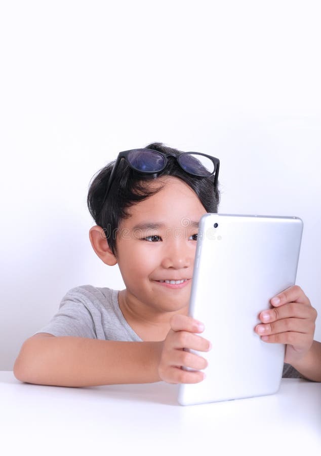 Young boy playing games on tablet royalty free stock photography Young boy playing games on tablet royalty free stock photography