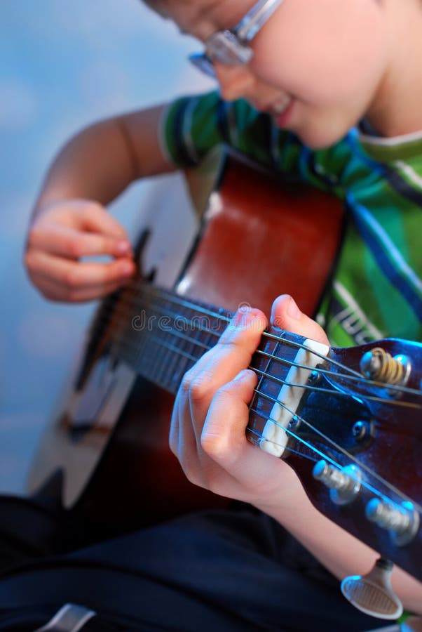 Young boy playing guitar stock image. Image of concert 30810259