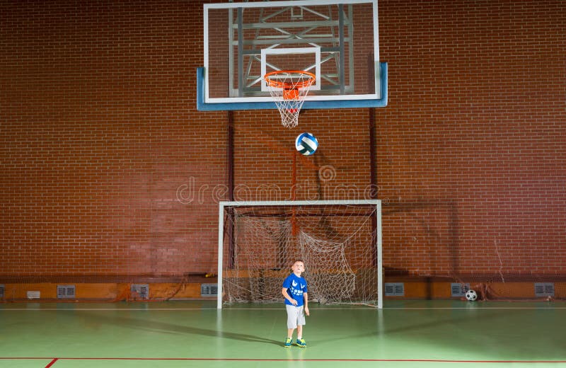 Young boy playing indoor soccer stock image Young boy playing indoor soccer stock image