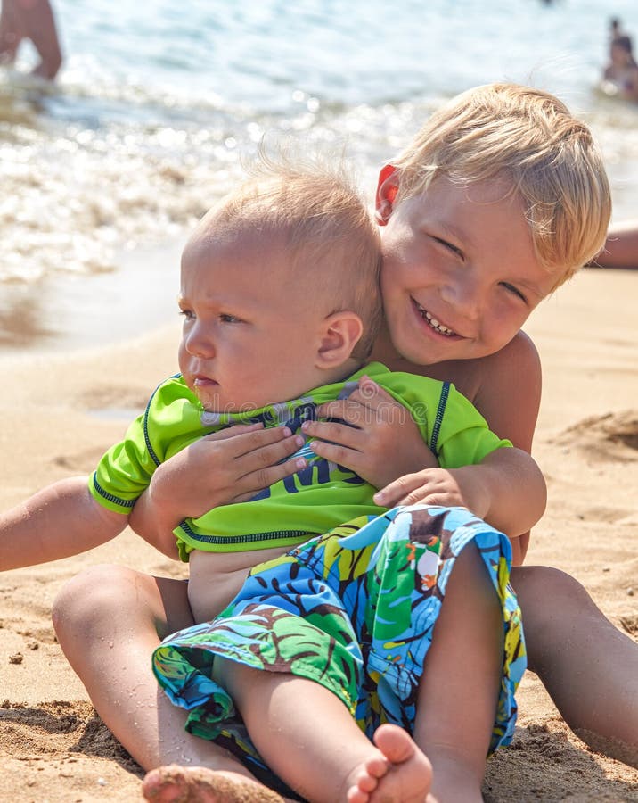 boy playing in the sand on the beach