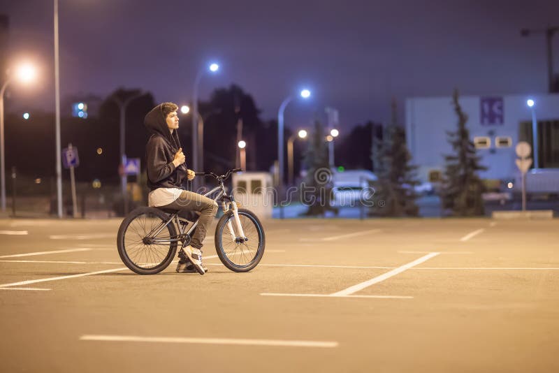 Young Boy Ride on Bike at the Evening Around Town Stock Photo Image