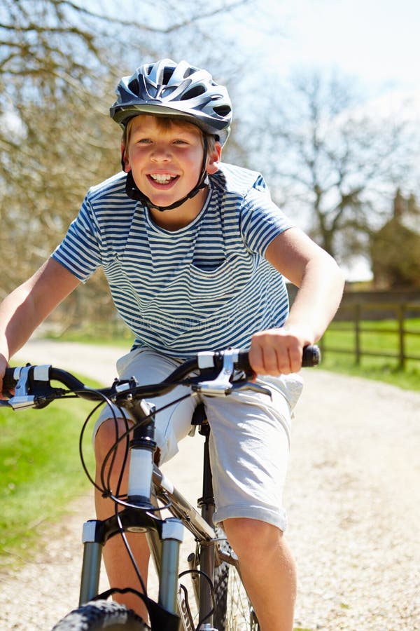Young Boy Riding Bike Along Country Track Stock Photo - Image of ...