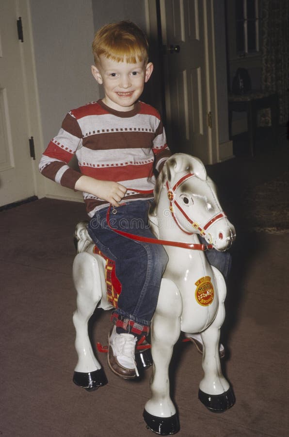 Young boy on rocking horse