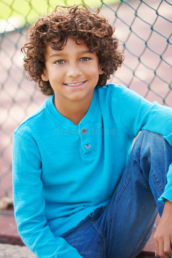 Young Boy Sitting On Bench In Park royalty free stock photos Young Boy Sitting On Bench In Park royalty free stock photos