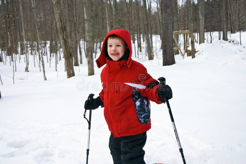 Young boy with ski poles