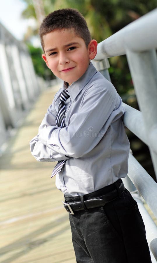 Young boy in suit with arms crossed