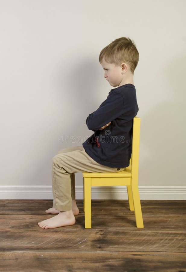 A young boy on a time out chair