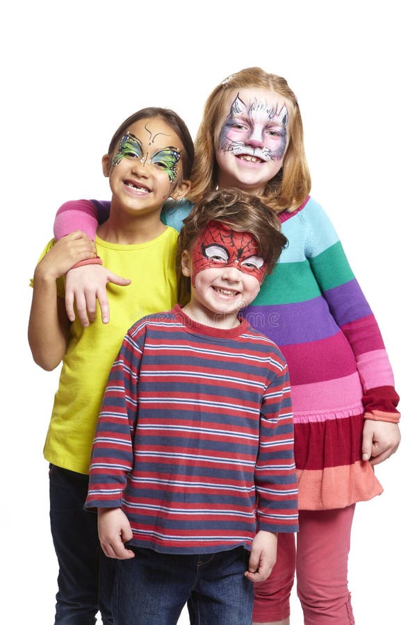 Young boy and two girls with face painting of cat, butterfly and. Spiderman smiling on white background stock photo Young boy and two girls with face painting of cat, butterfly and. Spiderman smiling on white background stock photo