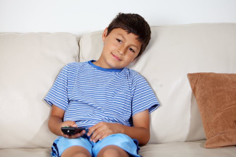 Young boy watching TV stock image. Image of remote, child 32954239