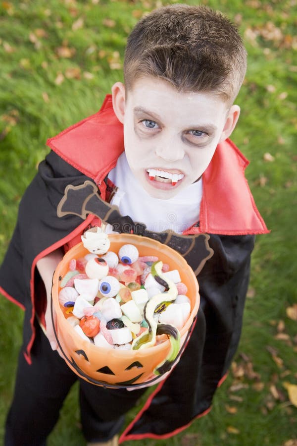 Young boy wearing vampire costume on Halloween