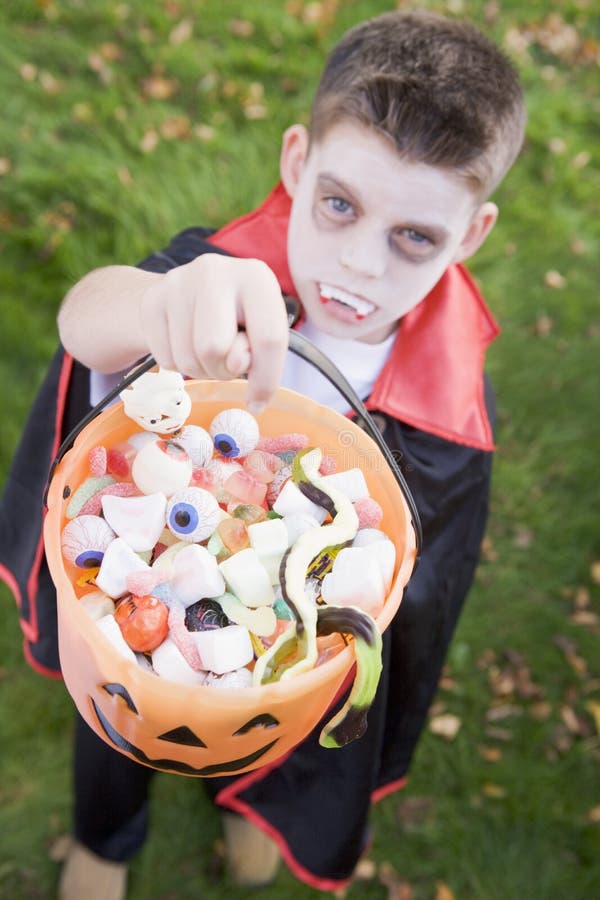 Young boy wearing vampire costume on Halloween