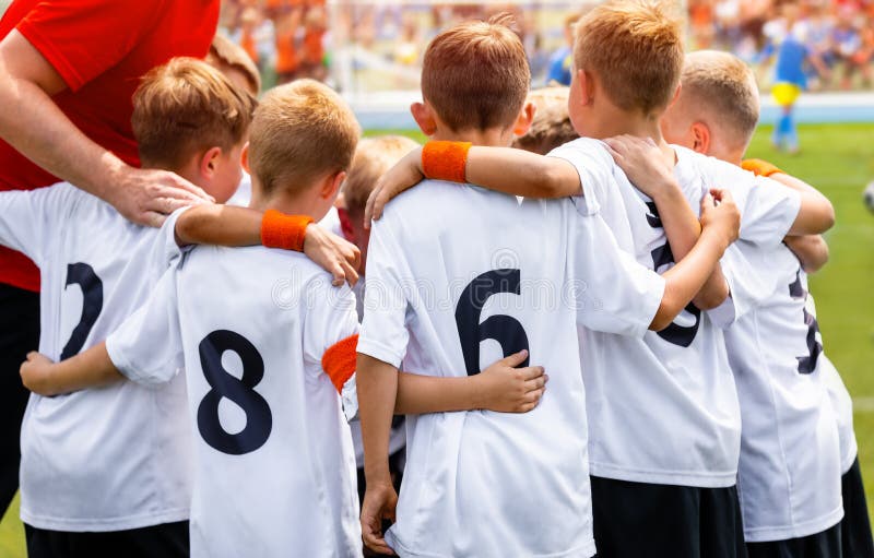 Young Boys In Football Team. Group Of Children In Soccer Team. School Football Coach’s Pregame Speech royalty free stock images Young Boys In Football Team. Group Of Children In Soccer Team. School Football Coach’s Pregame Speech royalty free stock images