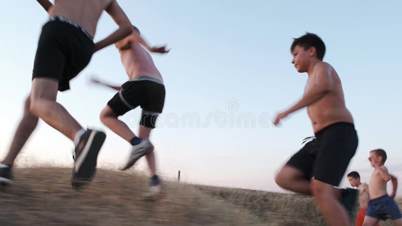 Young boys are jogging on a field