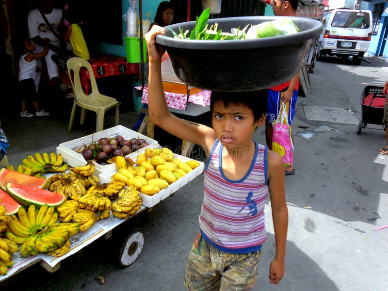 Young boys in a market in cainta, rizal, philippines selling fruits and vegetables royalty free stock image Young boys in a market in cainta, rizal, philippines selling fruits and vegetables royalty free stock image