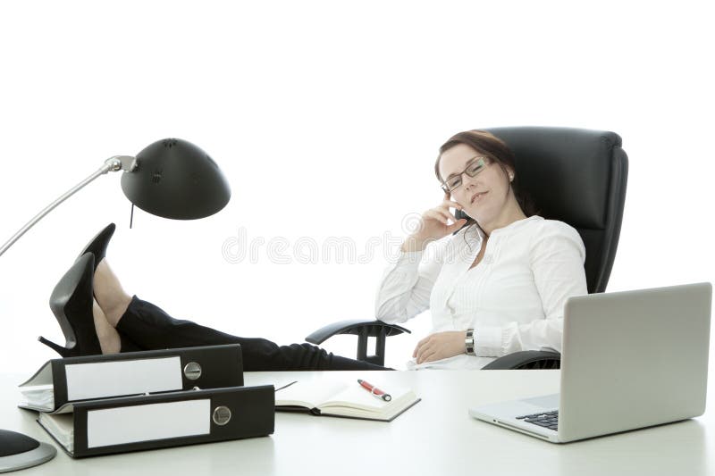 Young brunette businesswoman with glasses relax with feet on desk