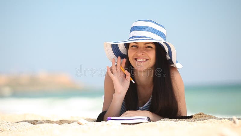 Young brunette girl with note and pencil